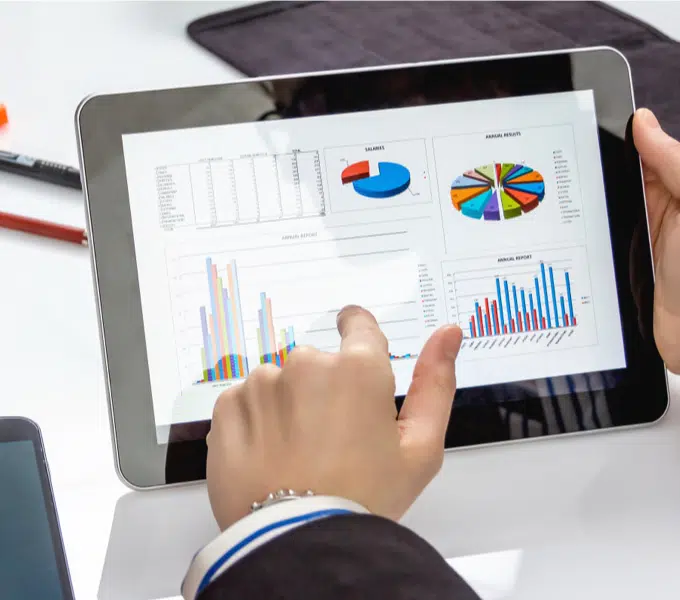 Person viewing charts and graphs on a tablet
