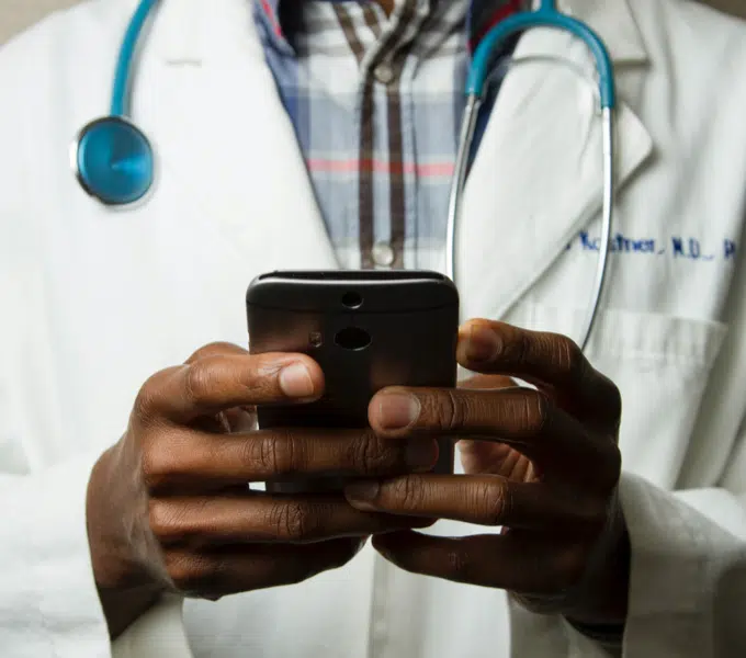 Doctor using a smartphone in a clinical setting