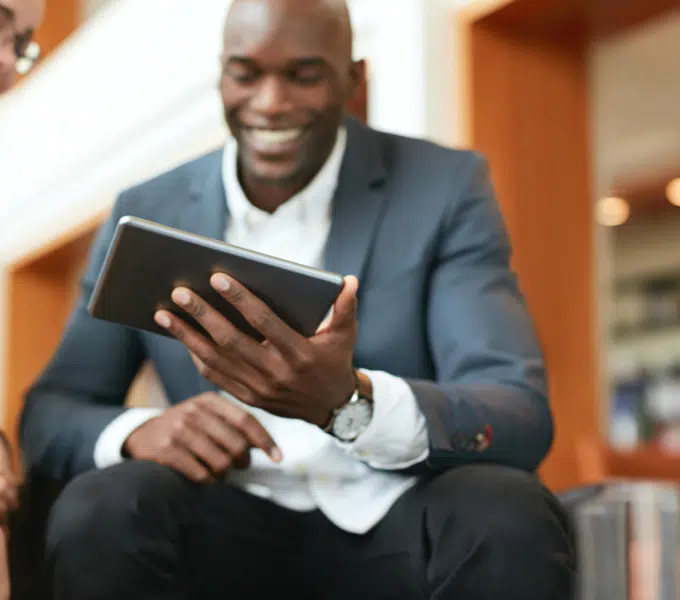 Professional smiling while viewing a tablet